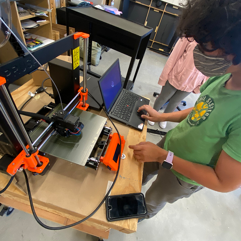 Student using a 3-D printer.