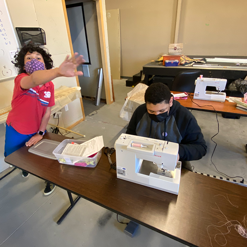 Two students in a sewing class.